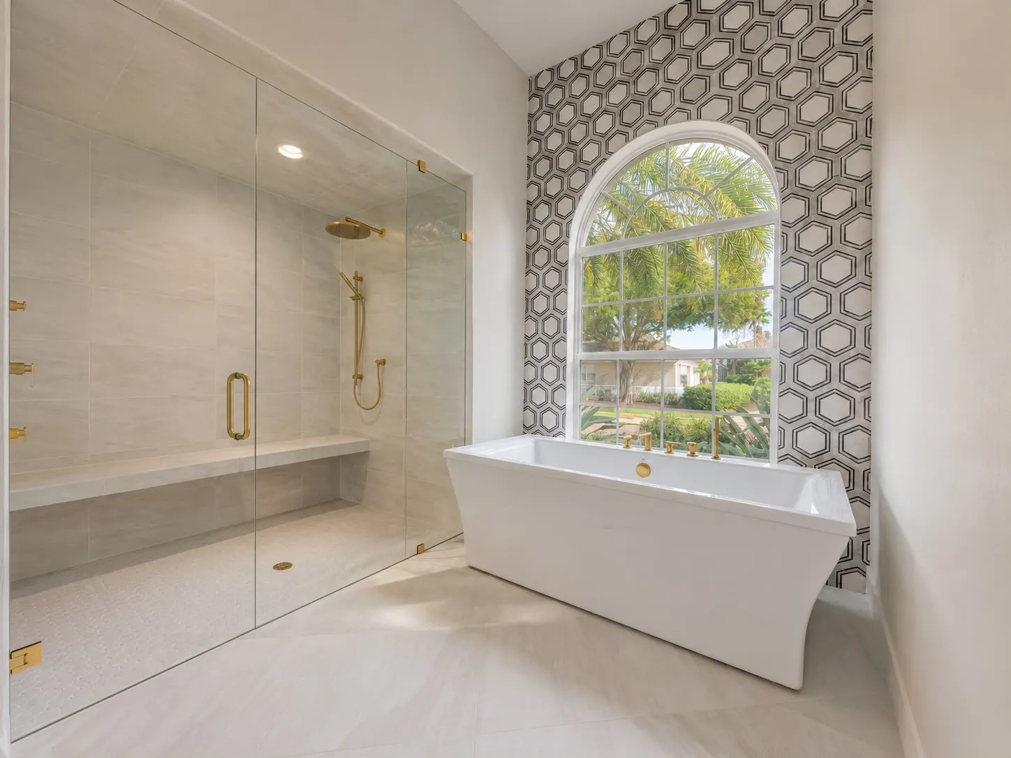 Primary bathroom with a freestanding tub, hexagon marble feature wall and a walk-in shower