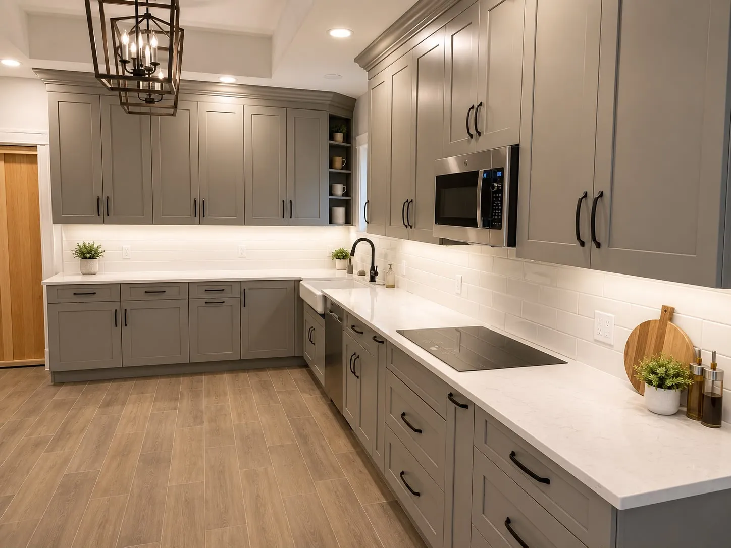 Grey shaker kitchen with quartz counters and a white subway tile backsplash