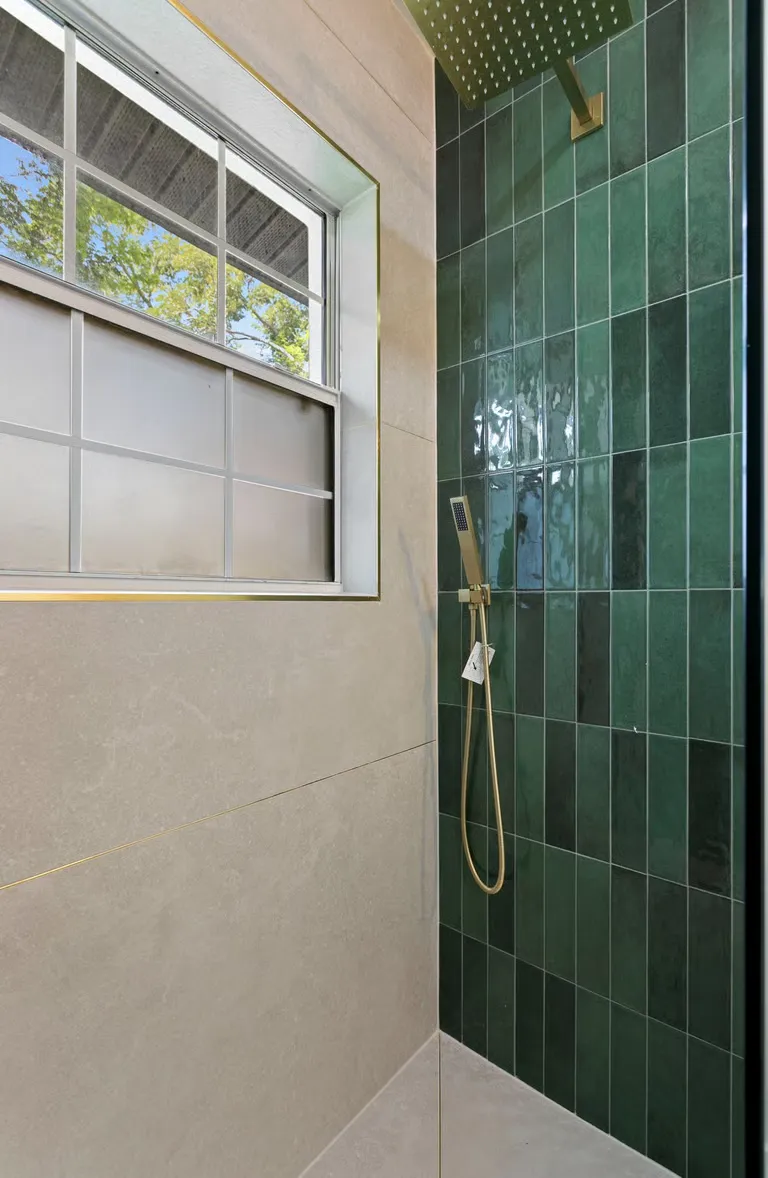Completed walk-in shower in glazed green tile