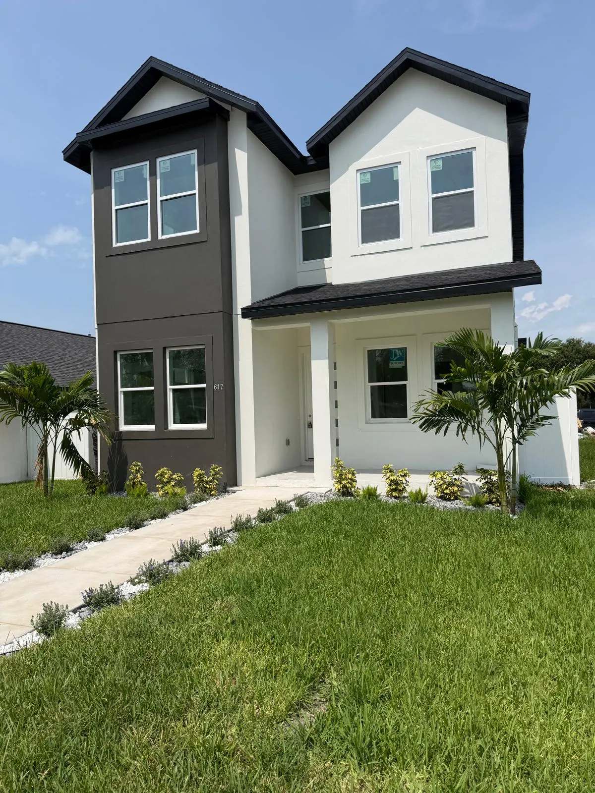 Completed two-story home with finished landscaping and walkway