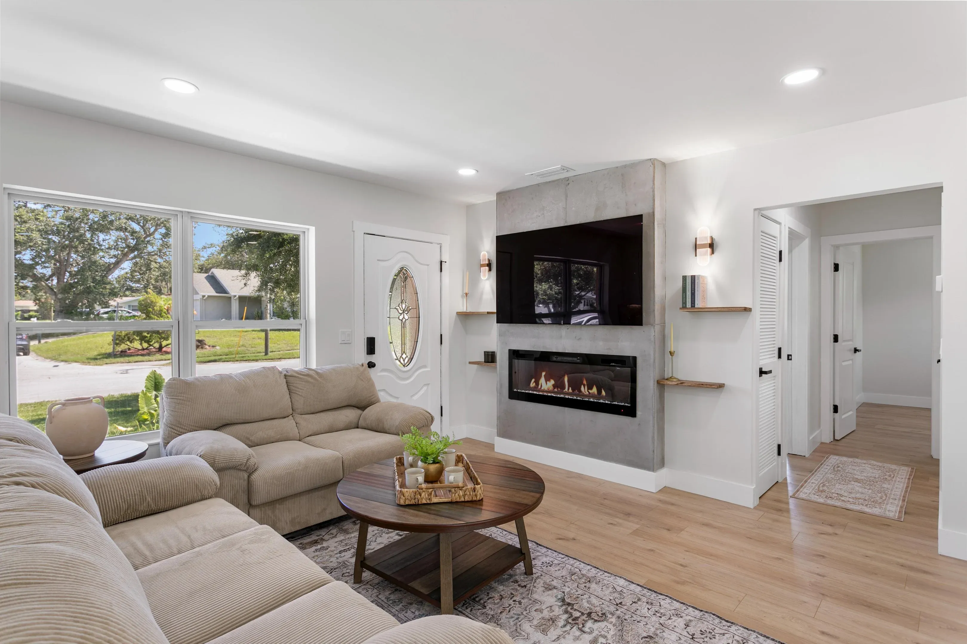 Open-plan living room with a rebuilt fireplace surround