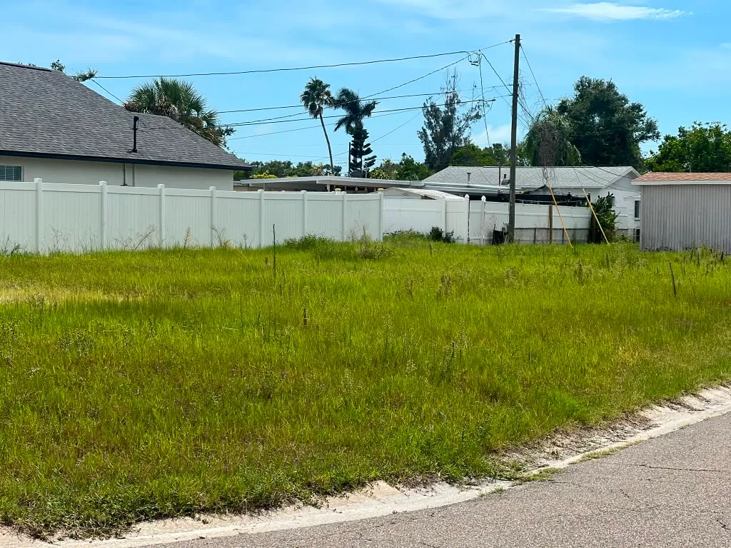 Cleared residential lot staked out before construction