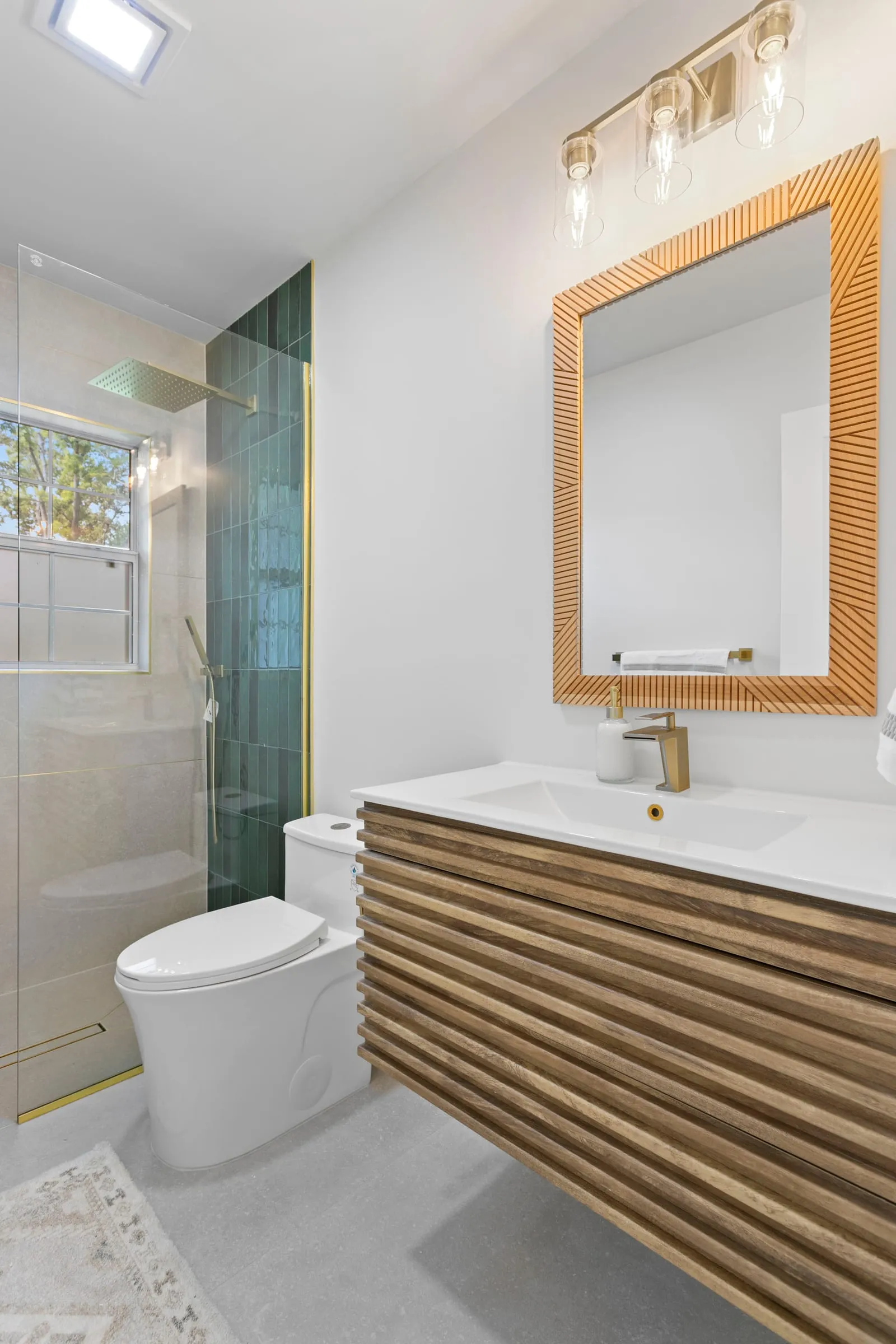 Rebuilt primary bathroom with a walk-in shower and a floating vanity